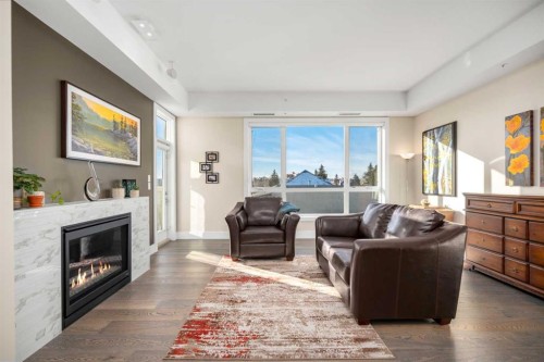 303-11 Burma Star Road Sw, Calgary, AB - Indoor Photo Showing Living Room With Fireplace