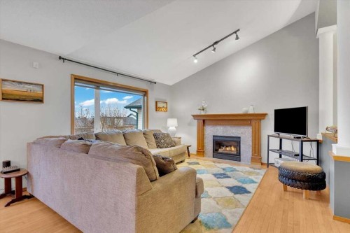 507 Sheep River Close, Okotoks, AB - Indoor Photo Showing Living Room With Fireplace