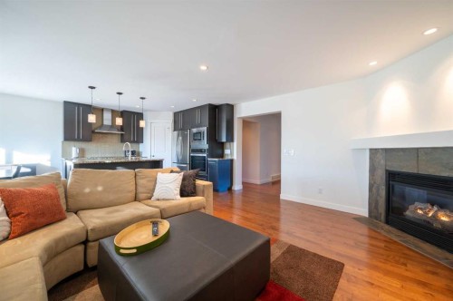 82 Chapalina Close Se, Calgary, AB - Indoor Photo Showing Living Room With Fireplace