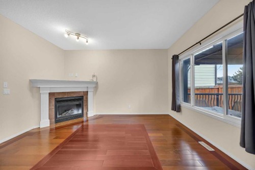 109 Bridlerange Place Sw, Calgary, AB - Indoor With Fireplace