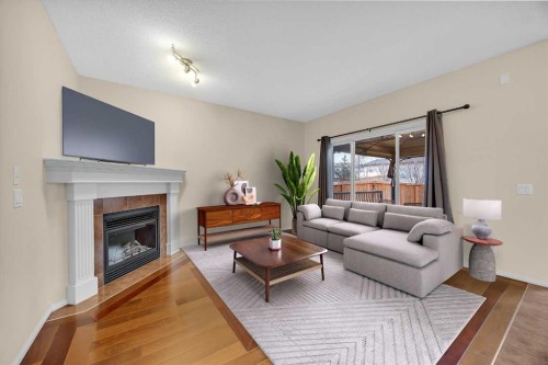 109 Bridlerange Place Sw, Calgary, AB - Indoor Photo Showing Living Room With Fireplace