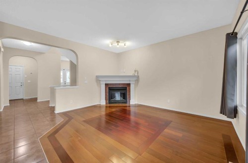 109 Bridlerange Place Sw, Calgary, AB - Indoor Photo Showing Living Room With Fireplace