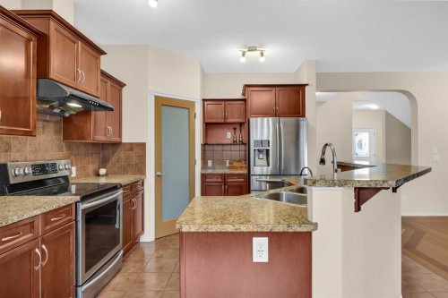 109 Bridlerange Place Sw, Calgary, AB - Indoor Photo Showing Kitchen With Stainless Steel Kitchen With Double Sink With Upgraded Kitchen