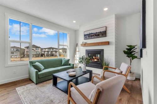 303 Kinniburgh Loop, Chestermere, AB - Indoor Photo Showing Living Room With Fireplace