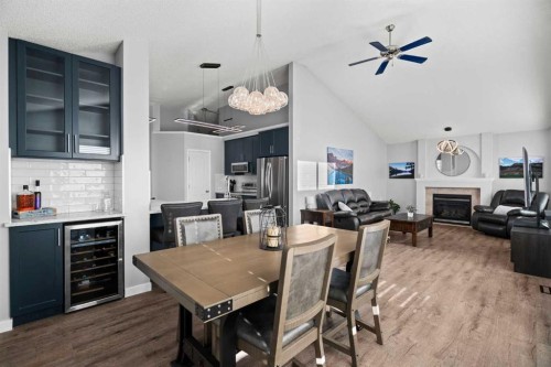 49 Somerside Close Sw, Calgary, AB - Indoor Photo Showing Dining Room With Fireplace