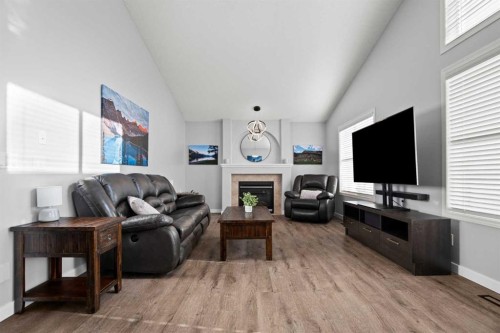 49 Somerside Close Sw, Calgary, AB - Indoor Photo Showing Living Room With Fireplace