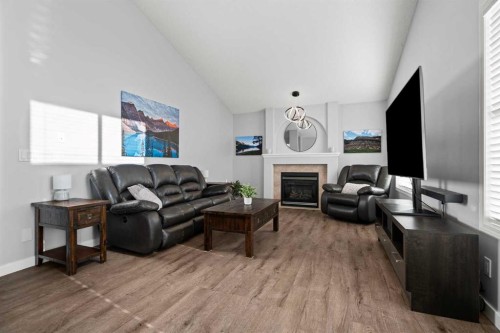 49 Somerside Close Sw, Calgary, AB - Indoor Photo Showing Living Room With Fireplace