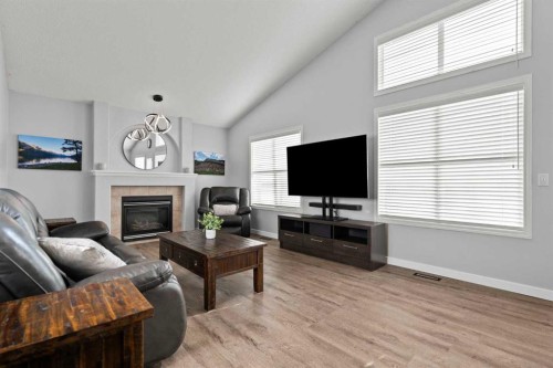 49 Somerside Close Sw, Calgary, AB - Indoor Photo Showing Living Room With Fireplace