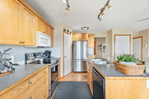 51 Westfall Crescent, Okotoks, AB - Indoor Photo Showing Kitchen With Double Sink