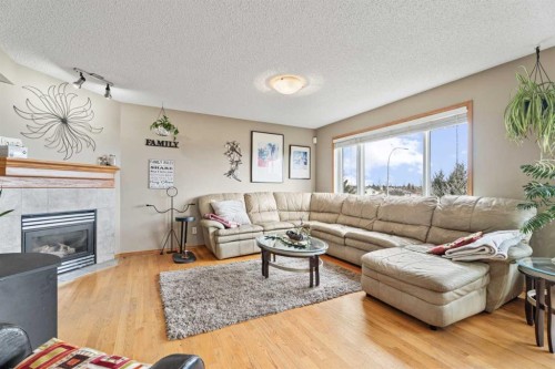 51 Westfall Crescent, Okotoks, AB - Indoor Photo Showing Living Room With Fireplace