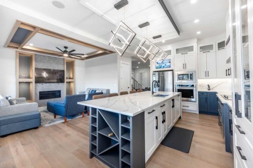 66 Waterford Road, Chestermere, AB - Indoor Photo Showing Kitchen With Fireplace With Upgraded Kitchen