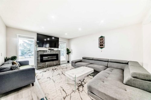 6712 23 Avenue Ne, Calgary, AB - Indoor Photo Showing Living Room With Fireplace