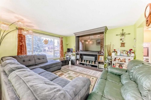 6411 26 Avenue Ne, Calgary, AB - Indoor Photo Showing Living Room With Fireplace