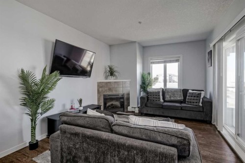 1318-604 East Lake Boulevard Ne, Airdrie, AB - Indoor Photo Showing Living Room With Fireplace