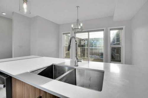 304-33 Merganser Drive West, Chestermere, AB - Indoor Photo Showing Kitchen With Double Sink