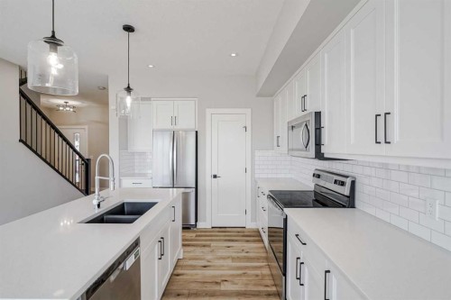 28 Willow Street, Cochrane, AB - Indoor Photo Showing Kitchen With Double Sink With Upgraded Kitchen