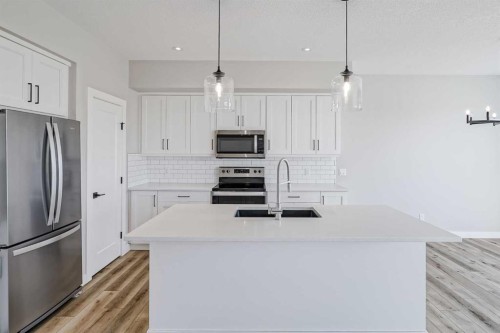 28 Willow Street, Cochrane, AB - Indoor Photo Showing Kitchen With Double Sink With Upgraded Kitchen