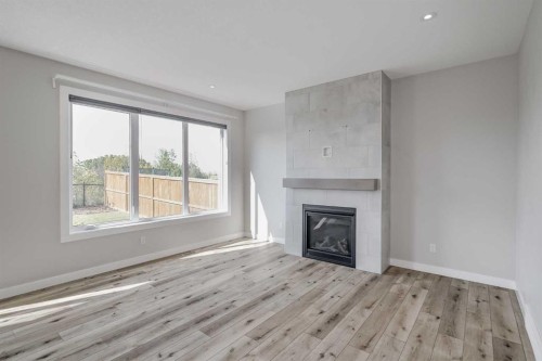 28 Willow Street, Cochrane, AB - Indoor Photo Showing Living Room With Fireplace