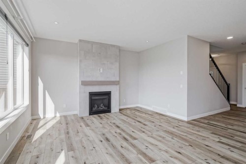 28 Willow Street, Cochrane, AB - Indoor Photo Showing Living Room With Fireplace