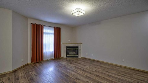 32 Mt Aberdeen Manor Se, Calgary, AB - Indoor Photo Showing Other Room With Fireplace