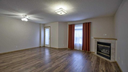 32 Mt Aberdeen Manor Se, Calgary, AB - Indoor Photo Showing Living Room With Fireplace