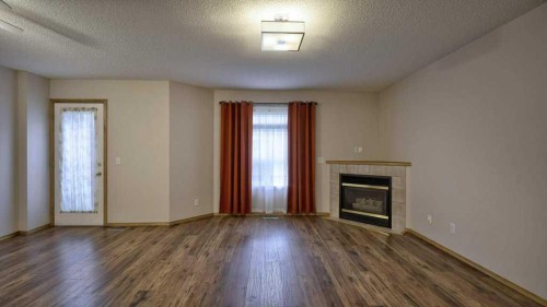 32 Mt Aberdeen Manor Se, Calgary, AB - Indoor Photo Showing Living Room With Fireplace