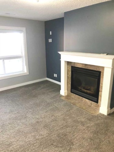 137 Coverton Circle Ne, Calgary, AB - Indoor Photo Showing Living Room With Fireplace