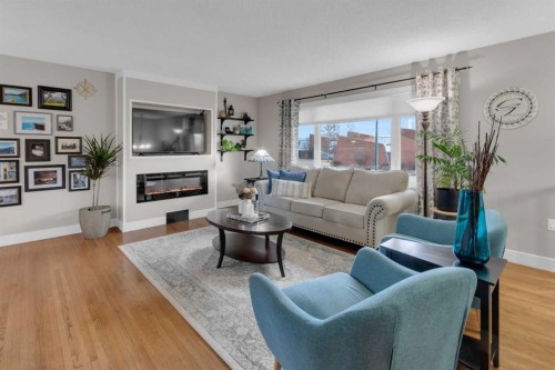 724 Mapleton Drive Se, Calgary, AB - Indoor Photo Showing Living Room With Fireplace
