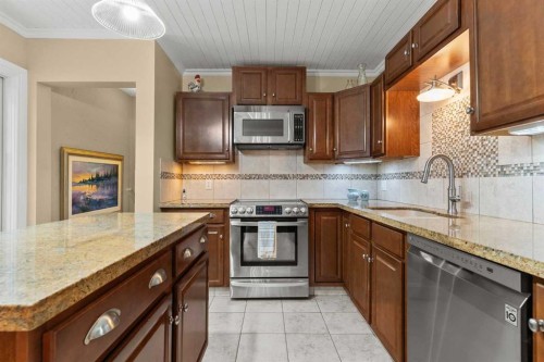 656 Royalite Way Se, Diamond Valley, AB - Indoor Photo Showing Kitchen With Upgraded Kitchen