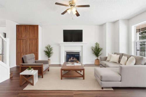 82 Bridleridge Way Sw, Calgary, AB - Indoor Photo Showing Living Room With Fireplace