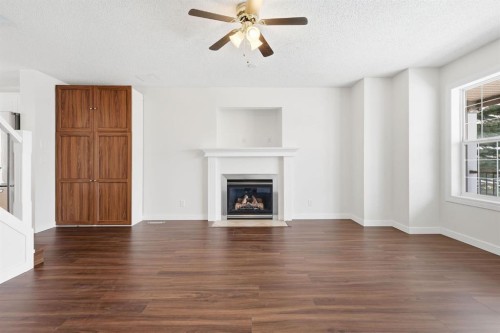 82 Bridleridge Way Sw, Calgary, AB - Indoor Photo Showing Living Room With Fireplace