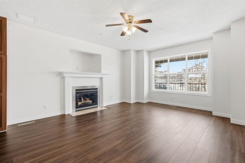 82 Bridleridge Way Sw, Calgary, AB - Indoor Photo Showing Living Room With Fireplace