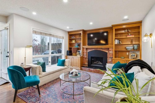 206 Signal Hill Point Sw, Calgary, AB - Indoor Photo Showing Living Room With Fireplace