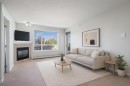 302-8200 4 Street Ne, Calgary, AB  - Indoor Photo Showing Living Room With Fireplace 