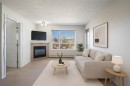 302-8200 4 Street Ne, Calgary, AB  - Indoor Photo Showing Living Room With Fireplace 