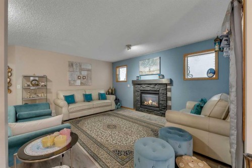 172 Covehaven Road Ne, Calgary, AB - Indoor Photo Showing Living Room With Fireplace