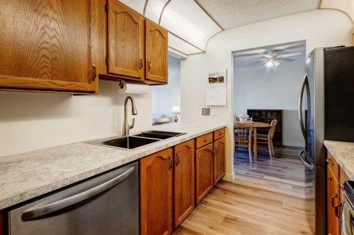 108-309 Woodside Drive Nw, Airdrie, AB - Indoor Photo Showing Kitchen With Double Sink