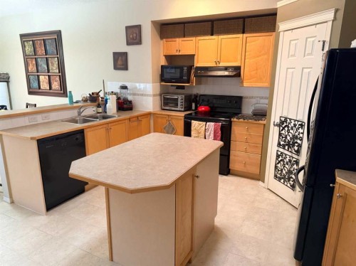 61 Everwoods Close Sw, Calgary, AB - Indoor Photo Showing Kitchen With Double Sink