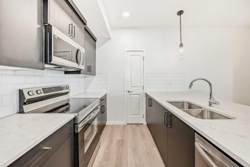 212-245 Edith Place Nw, Calgary, AB - Indoor Photo Showing Kitchen With Stainless Steel Kitchen With Double Sink With Upgraded Kitchen
