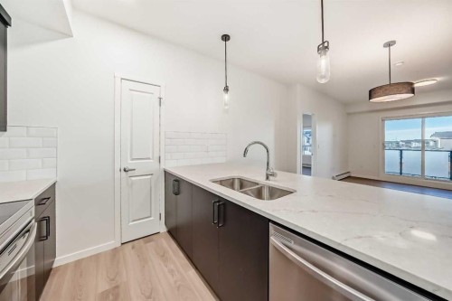 212-245 Edith Place Nw, Calgary, AB - Indoor Photo Showing Kitchen With Double Sink With Upgraded Kitchen