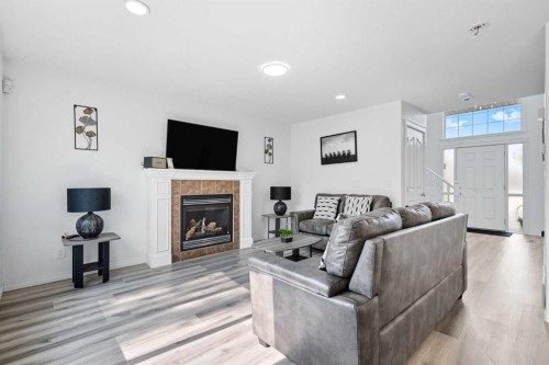 129 Luxstone Green Sw, Airdrie, AB - Indoor Photo Showing Living Room With Fireplace
