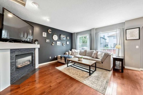 119 Bridlecreek Terrace, Calgary, AB - Indoor Photo Showing Living Room With Fireplace