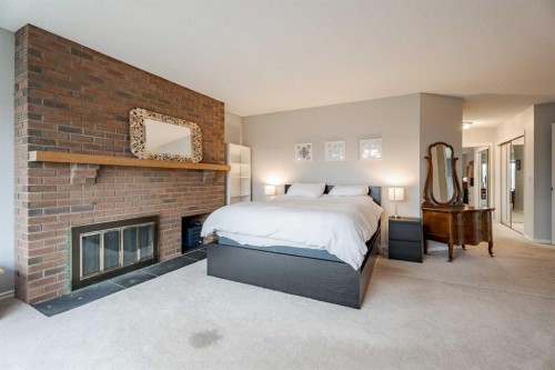 2427 Deer Side Drive, Calgary, AB - Indoor Photo Showing Bedroom With Fireplace