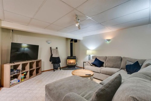 1324 Lake Sylvan Drive Se, Calgary, AB - Indoor Photo Showing Living Room With Fireplace