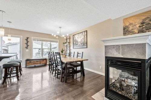354 Cranford Drive Se, Calgary, AB - Indoor Photo Showing Dining Room With Fireplace