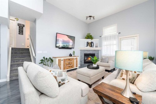 3-41 Hunters Gate, Okotoks, AB - Indoor Photo Showing Living Room With Fireplace