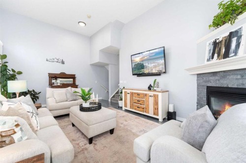 3-41 Hunters Gate, Okotoks, AB - Indoor Photo Showing Living Room With Fireplace