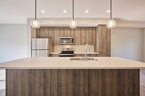 444 Shawnee Square Sw, Calgary, AB - Indoor Photo Showing Kitchen With Stainless Steel Kitchen With Double Sink With Upgraded Kitchen
