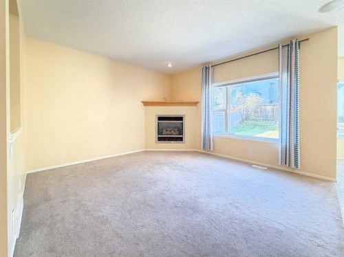 21 Panamount Hill Nw, Calgary, AB - Indoor Photo Showing Living Room With Fireplace