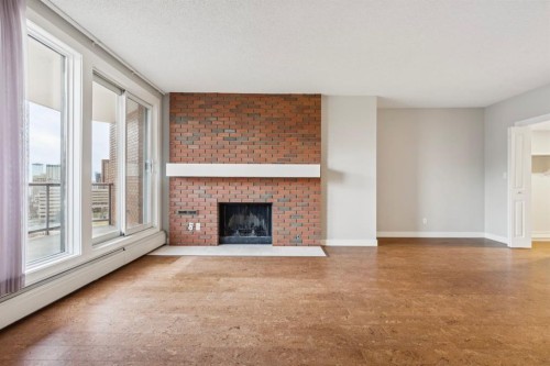 2D-215 2 Street Ne, Calgary, AB - Indoor Photo Showing Living Room With Fireplace